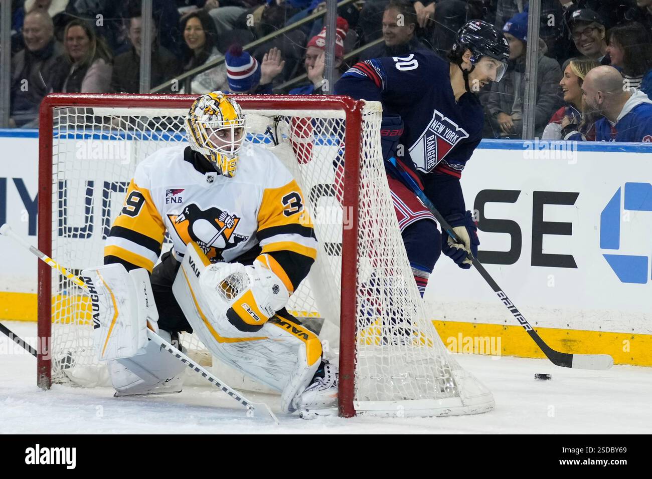 Pittsburgh Penguins goaltender Alex Nedeljkovic, left, watches as New