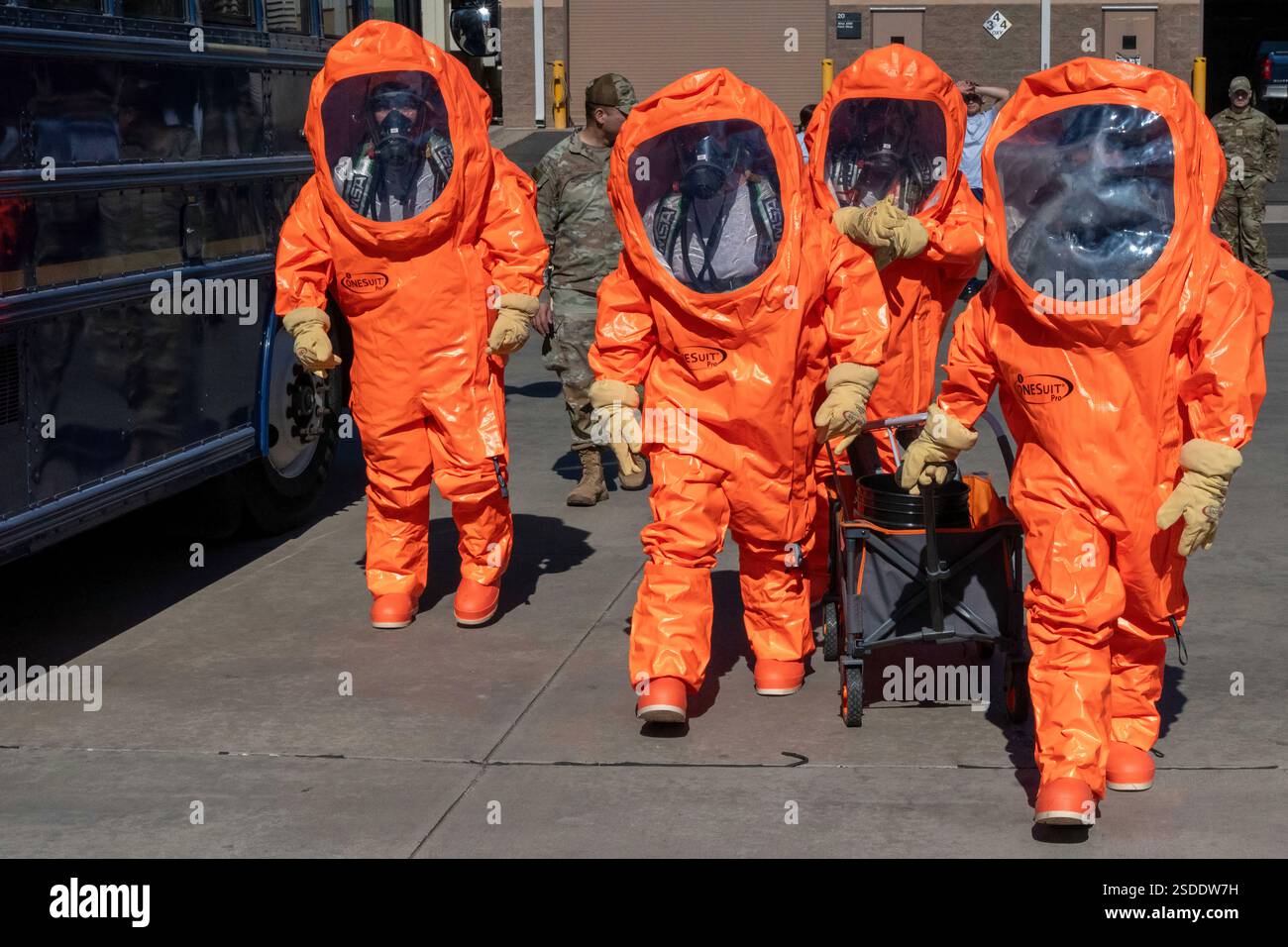 Chemical, biological, radiological, nuclear, or explosives Airmen walk in their Level A suits, the highest level of protection against any chemical vapor or splash field, during a field training exercise at Goldwater Air National Guard base, Phoenix, Jan. 31, 2025. The exercise included a a full day of CBRNE instruction with Airmen from across Arizona. (U.S. Air National Guard photo by Master Sgt. Michael Matkin) Stock Photo