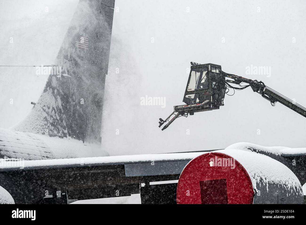 A guardsman assigned to the 171st Maintenance Group uses a deicer vehicle to blow the snow off of a KC-135 Stratotanker aircraft Dec. 20, 2024, at the 171st Air Refueling Wing near Pittsburgh, Pennsylvania. The aircraft has to be clear of snow and ice before takeoff.  (U.S. Air National Guard photo by Tech. Sgt. Zoe M. Wockenfuss) Stock Photo