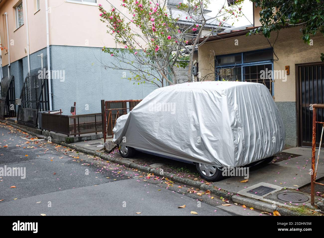 A car covered by a sheet in Japan. Stock Photo
