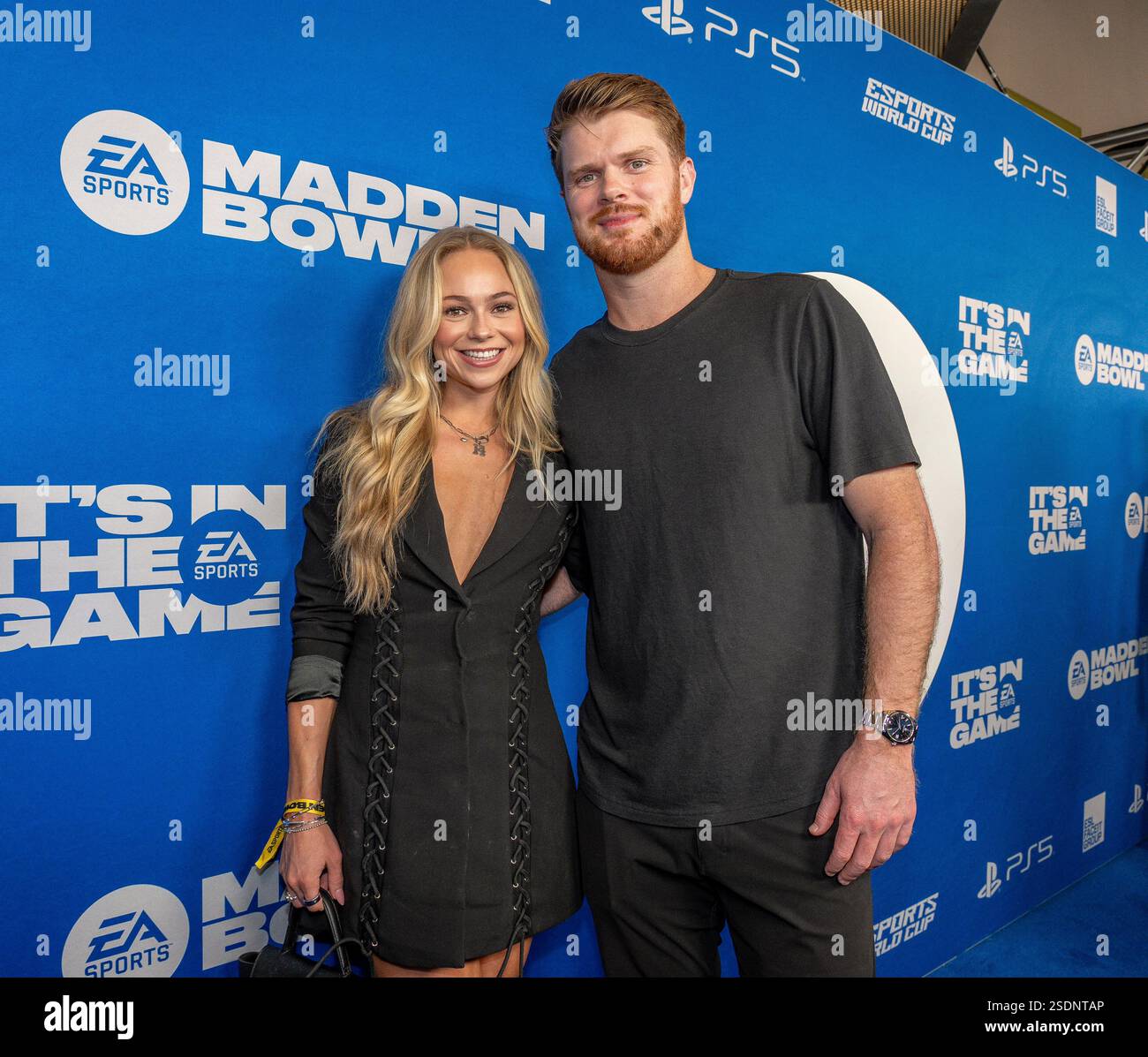 Katie Hoofnagle, left and Sam Darnold attend the EA Sports Madden Bowl