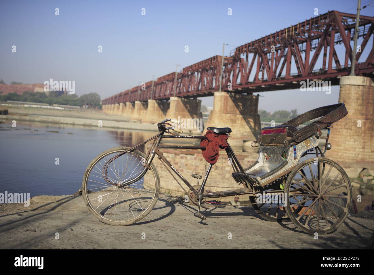 Cycle rickshaw in background combined bridge for railway and road ...