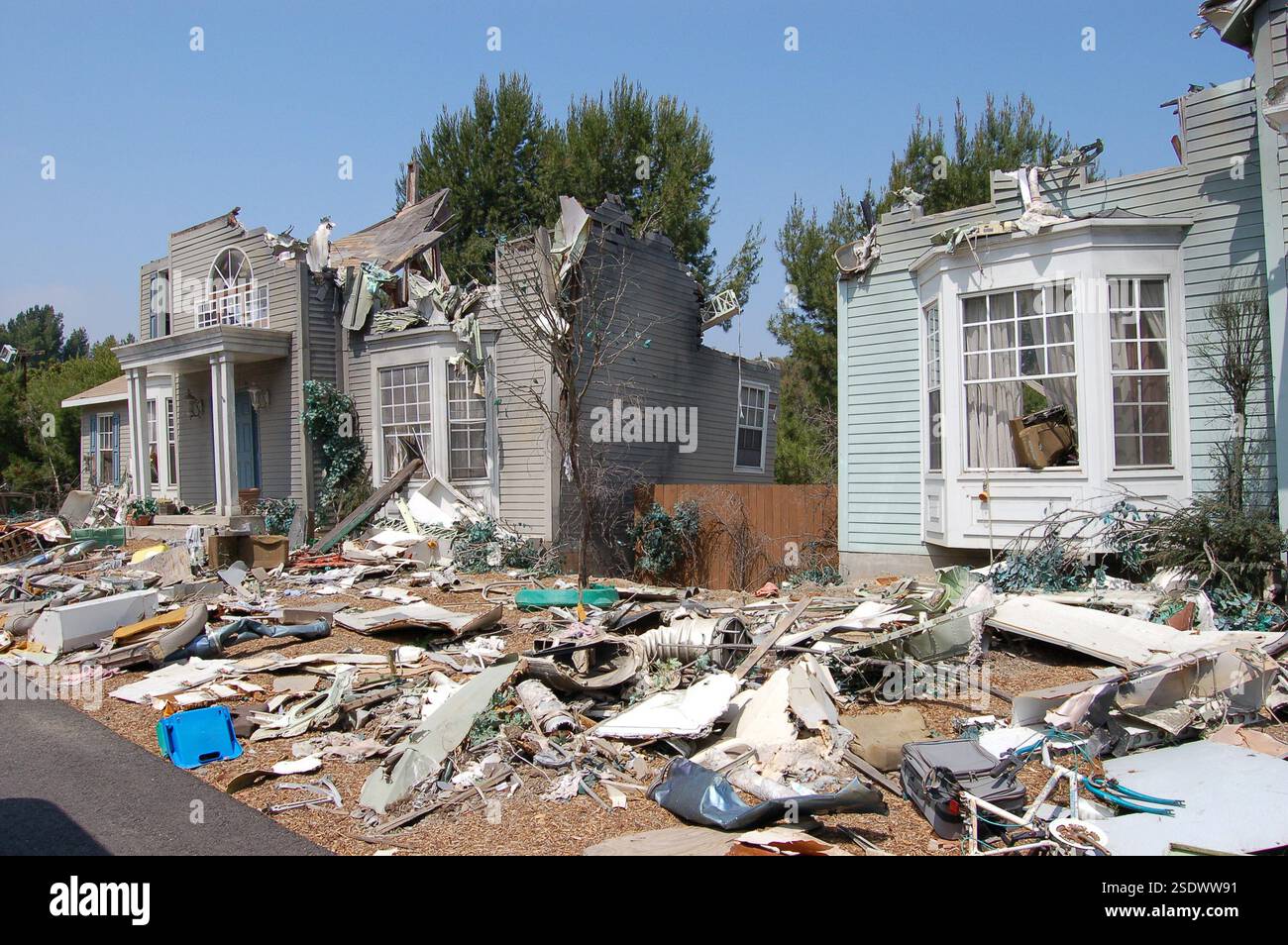 A severely damaged house after a powerful hurricane, with debris scattered around, showcasing the devastating impact of extreme weather and natural di Stock Photo