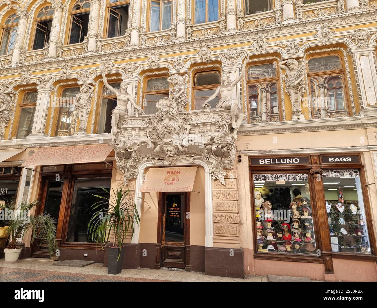 Ornate sculptures as decorations of an entrance (of cafe Beri Da Esh) in Passazh, a covered shopping arcade and hotel in Odesa / Odessa, Ukraine - Smartphone Captured Stock Image