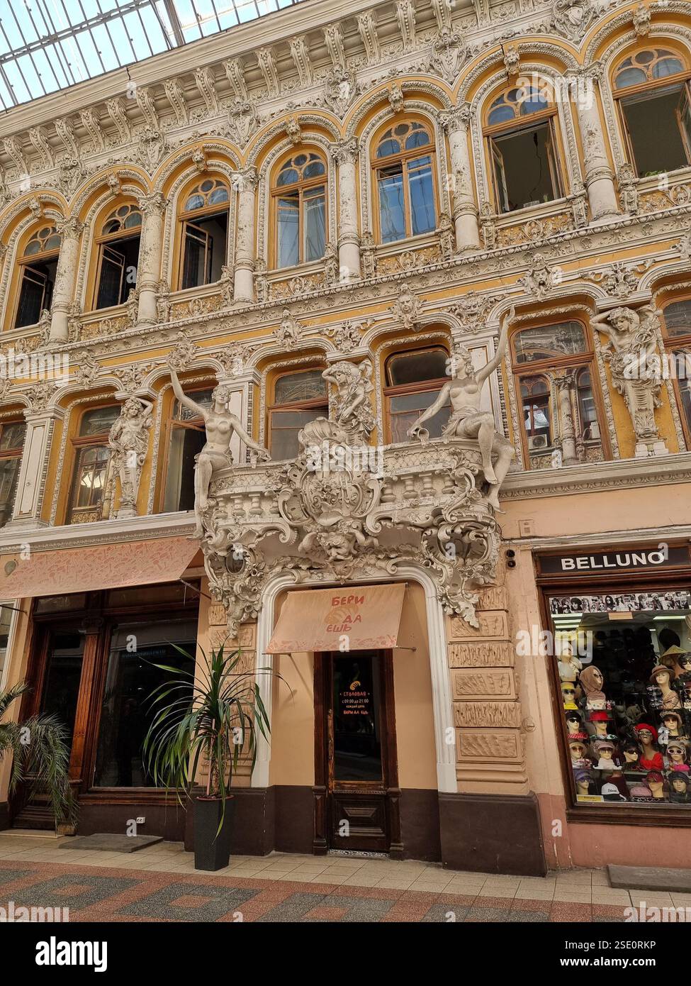 Ornate sculptures as decorations of an entrance (of cafe Beri Da Esh) in Passazh, a covered shopping arcade and hotel in Odesa / Odessa, Ukraine - Smartphone Captured Stock Image