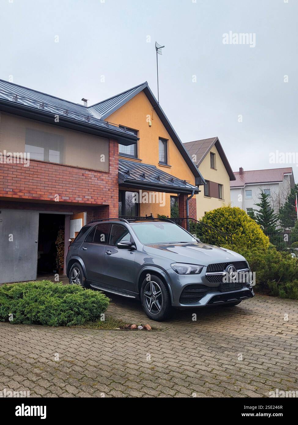 Vilnius, Lithuania - 2025-01-29 - Diesel-electric hybrid Mercedes GLE in the courtyard of a private house, ready for a comfortable trip for a large fa Stock Photo