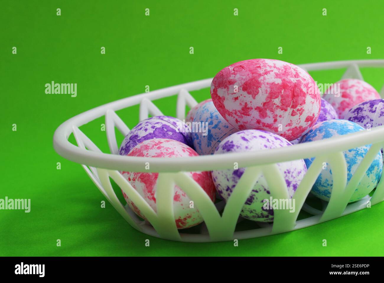 Colorful Easter Eggs with Spots in Plastic Basket Stock Photo