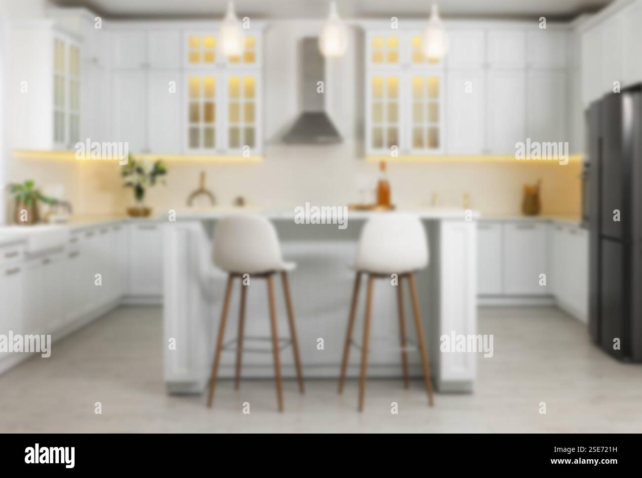 Dining table, chairs and other furniture in room, blurred view. Kitchen ...