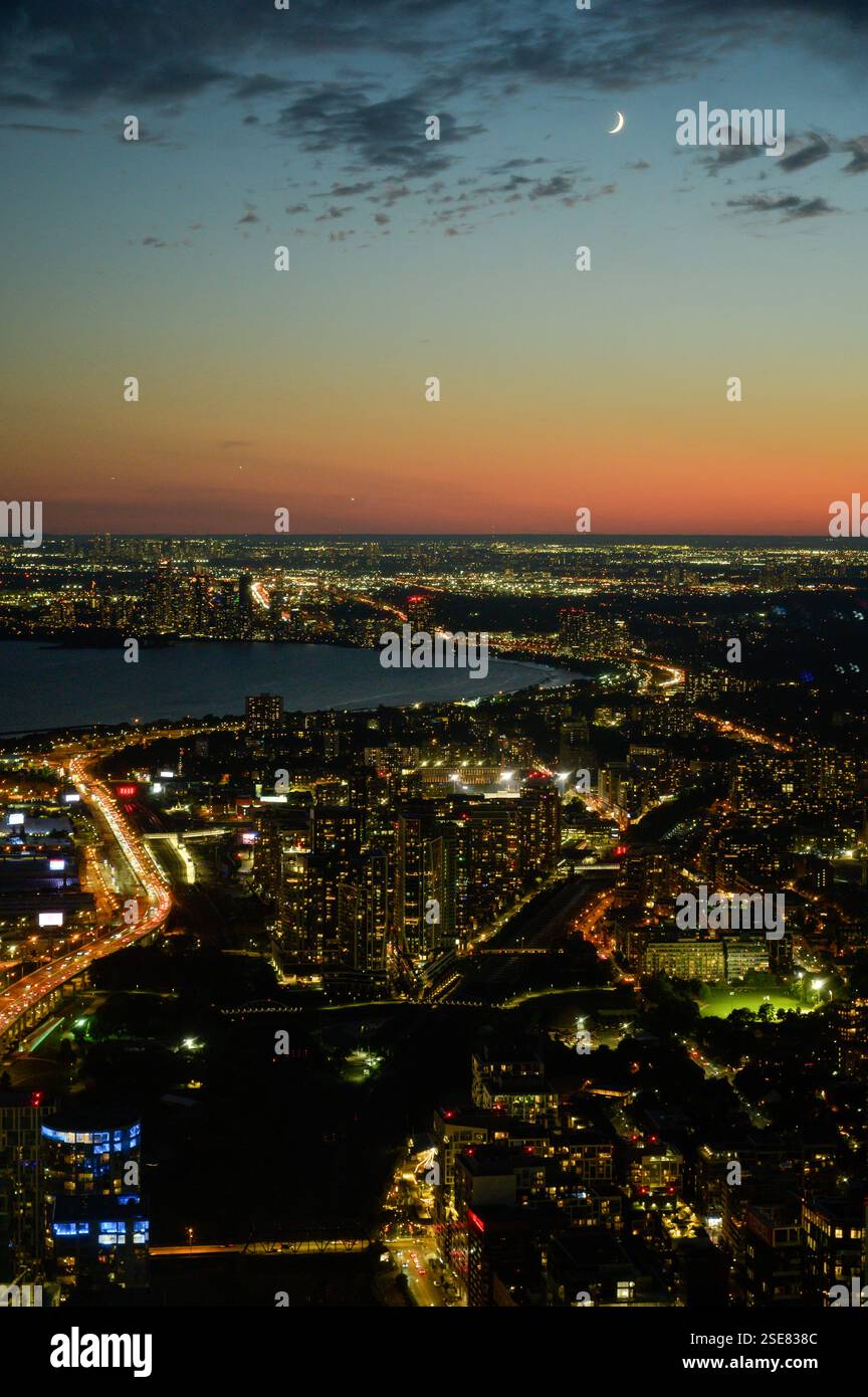 A stunning city skyline is illuminated as dusk falls, highlighting the ...