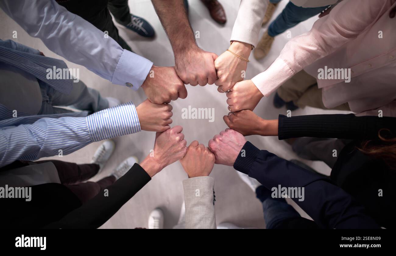 Business Team United in Effort to Stack Hands in Circle Stock Photo