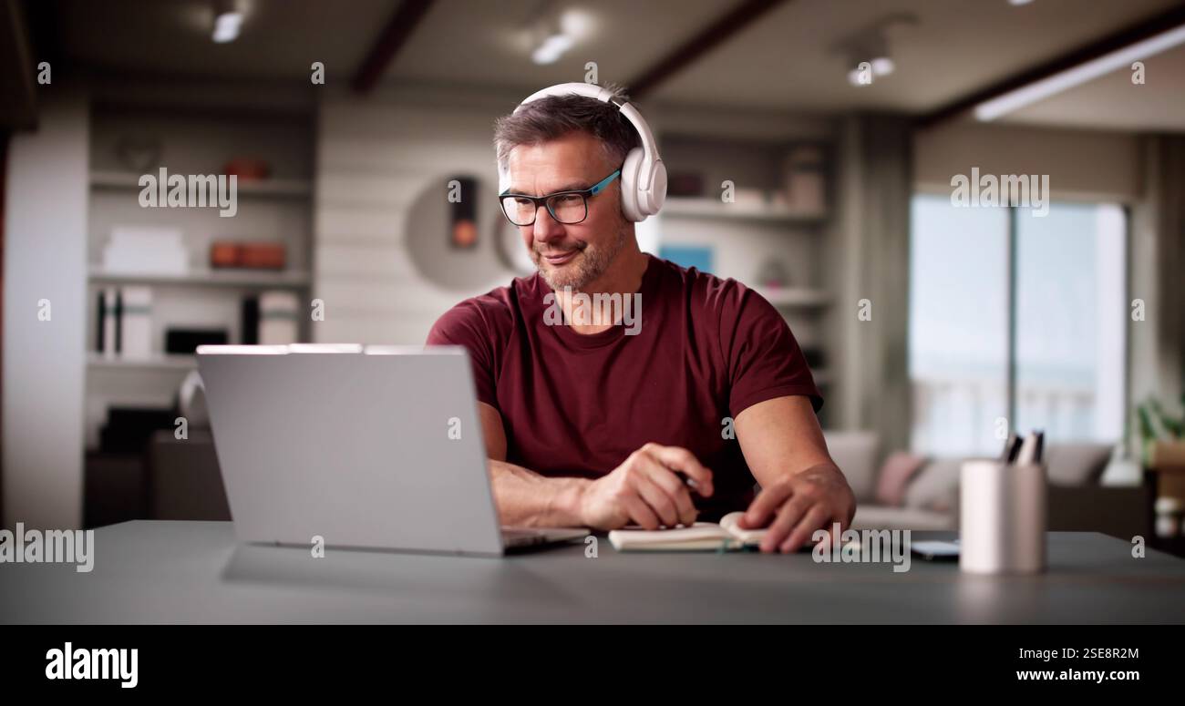 College Teacher At Home Using Laptop Computer Stock Photo