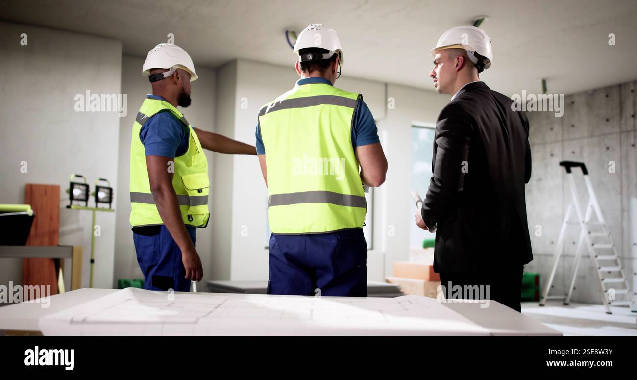 Businessman and construction engineer team up at apartment site renovation. Stock Photo