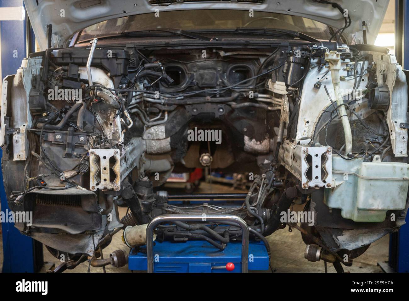 a lifted up car with removed broken engine, indoor shot Stock Photo - Alamy
