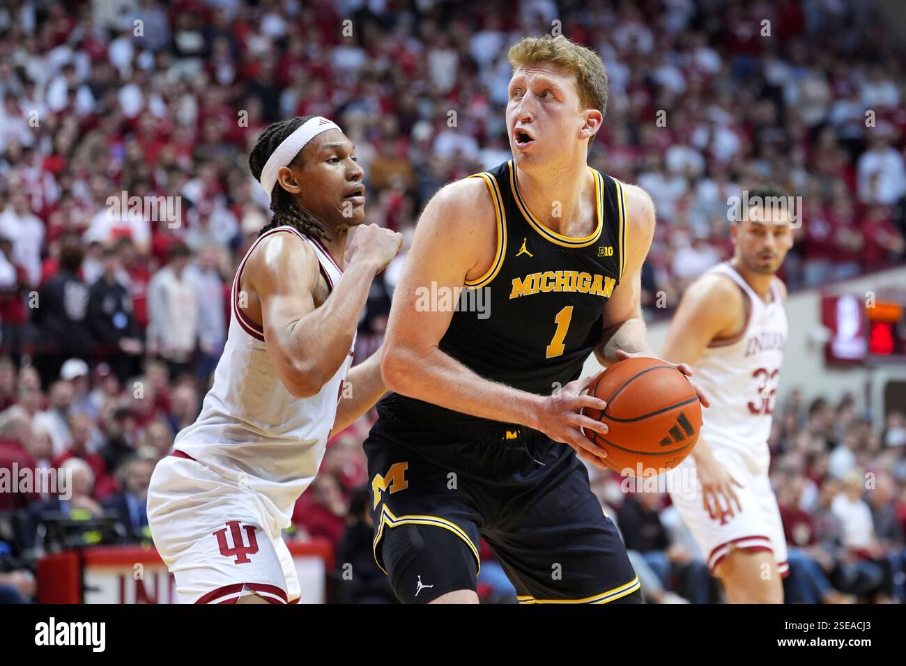 Michigan's Danny Wolf (1) spins toward the basket as Indiana's Malik ...