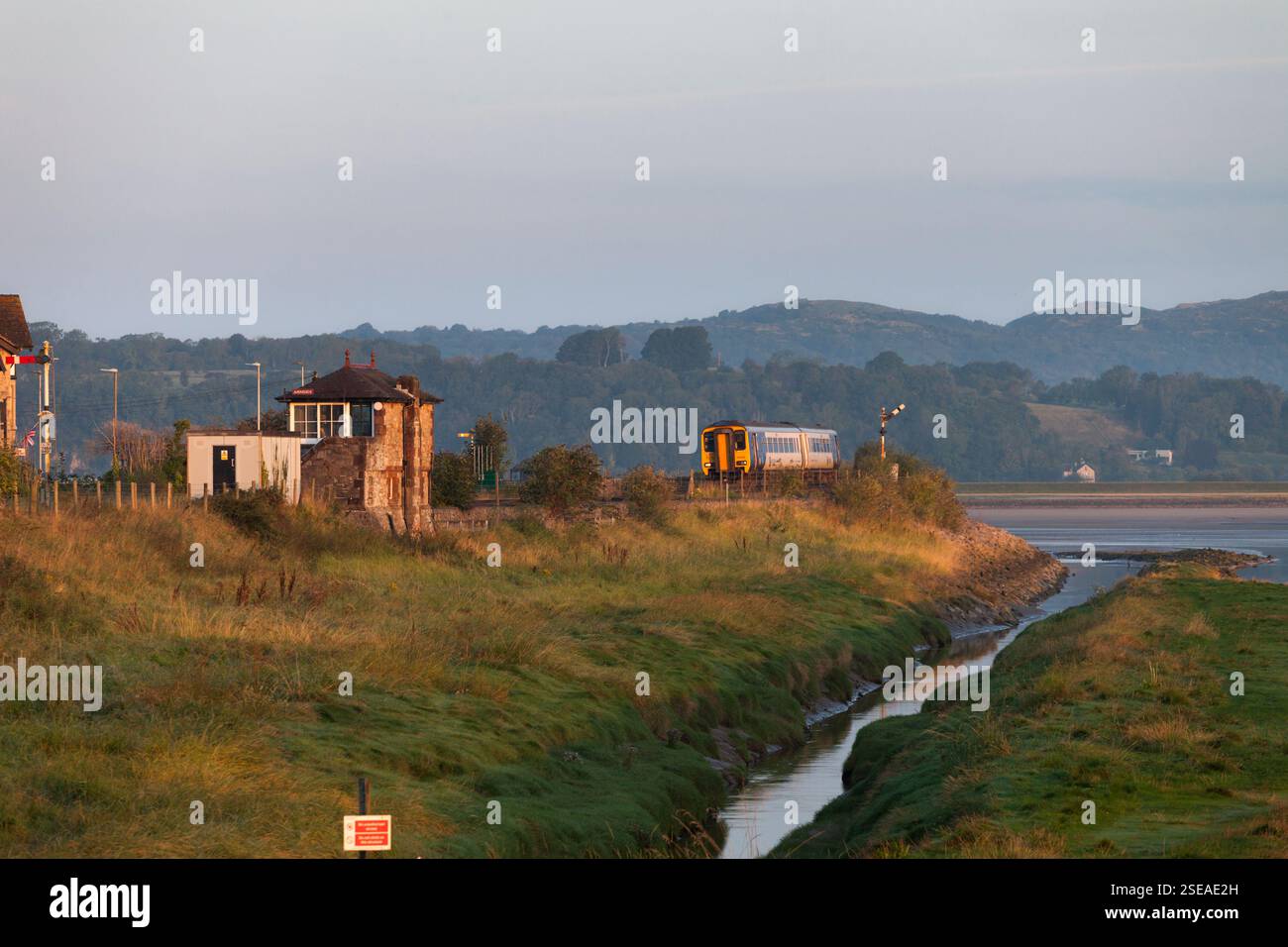 Northern Rail class 156 sprinter train passing Arnside signalbox on the ...