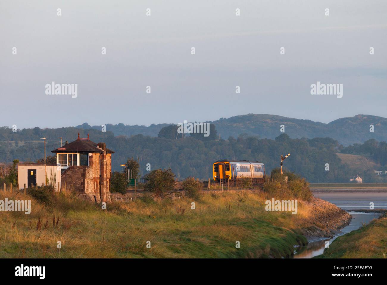 Northern Rail class 156 sprinter train passing Arnside signalbox on the ...