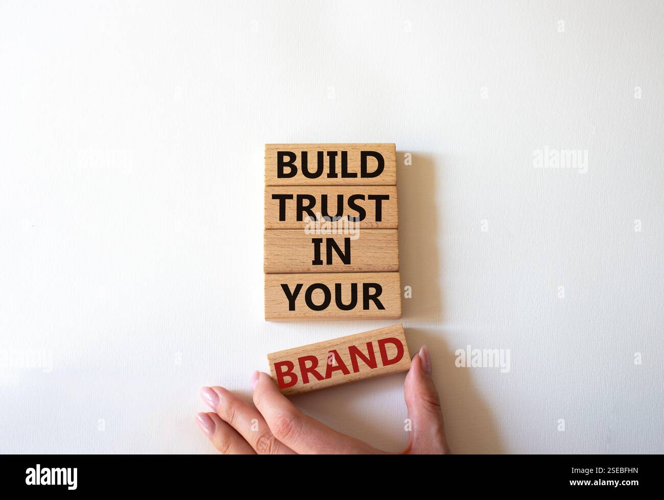 Build trust in your brand symbol. Wooden blocks with words Build trust ...
