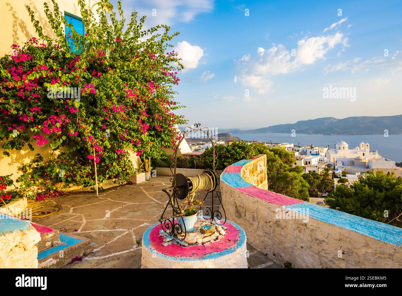 Whitte Terrace of typical whitte house with blue windows and flowers and cacti ...