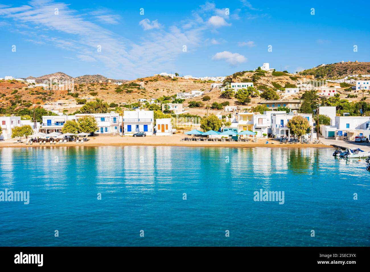 View of Kimolos port with white houses and beach, Kimolos island ...