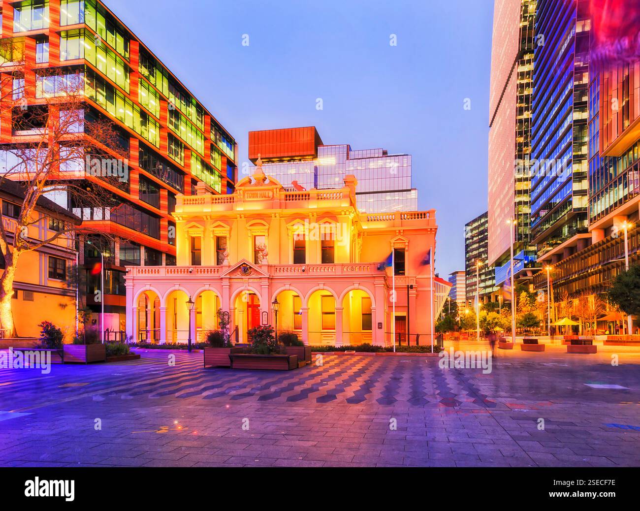 Parramatta city historic Town Hall building at sunset surrounded by modern urban skyscrapter towers in Australia. Stock Photo