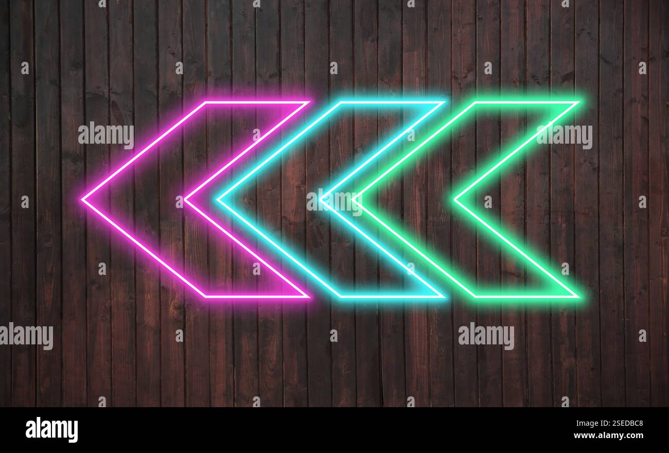 Bright neon arrow-shaped pointer on wooden wall Stock Photo