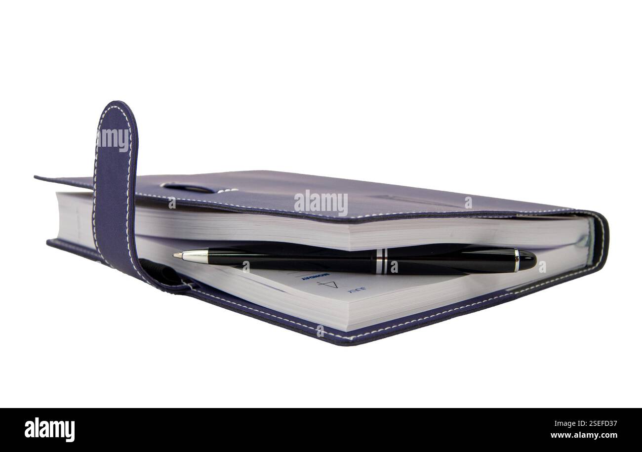 ballpoint pen is laying in paper notebook Stock Photo