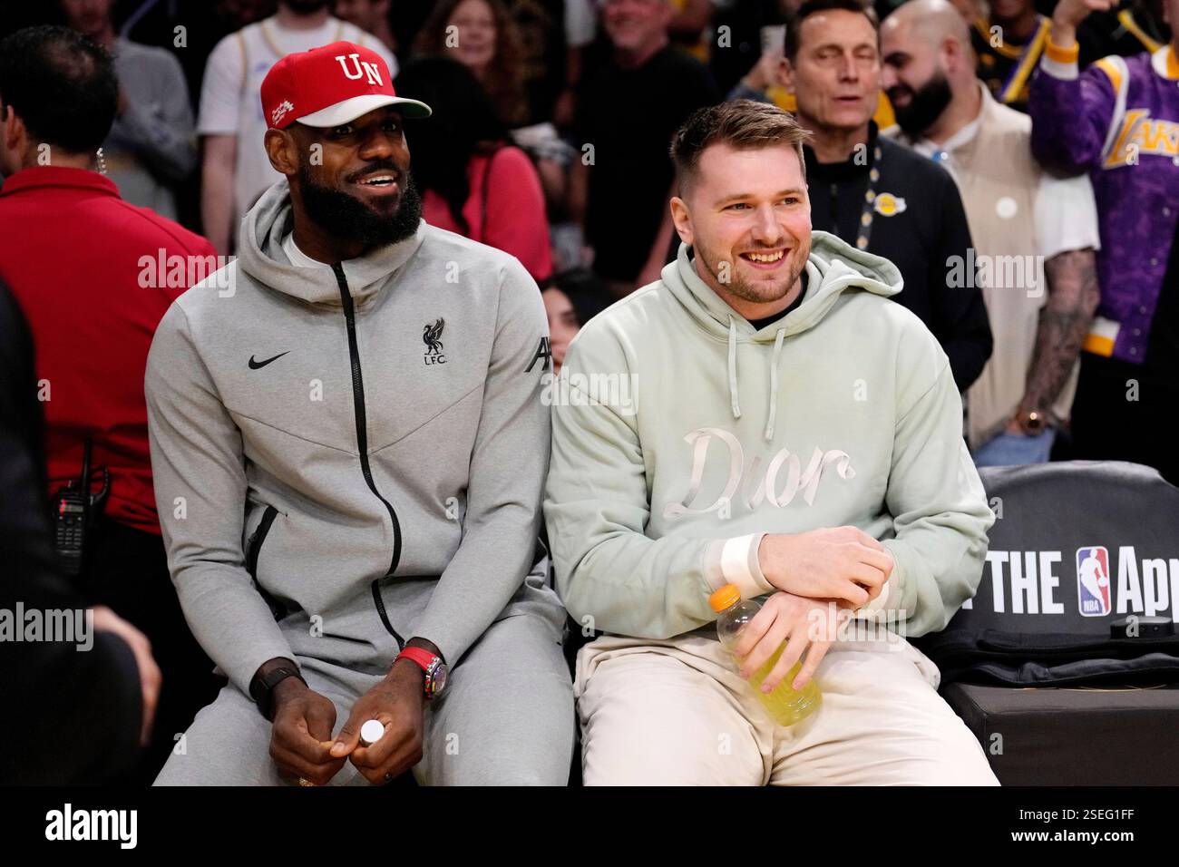 Los Angeles Lakers' LeBron James, left, and Luka Doncic sits together ...
