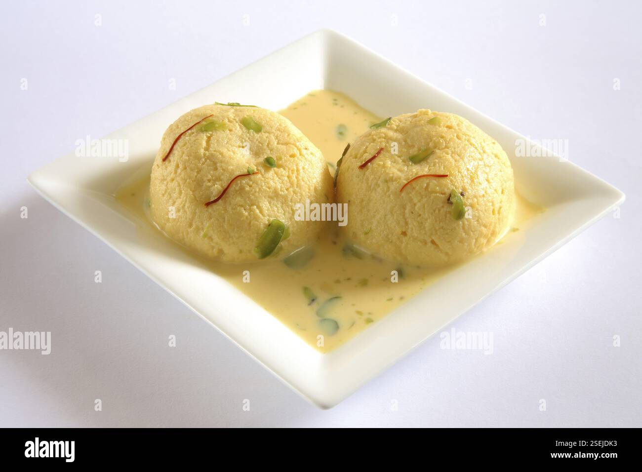 Indian sweet, kesar rasmalai garnish with pistachio and saffron served ...