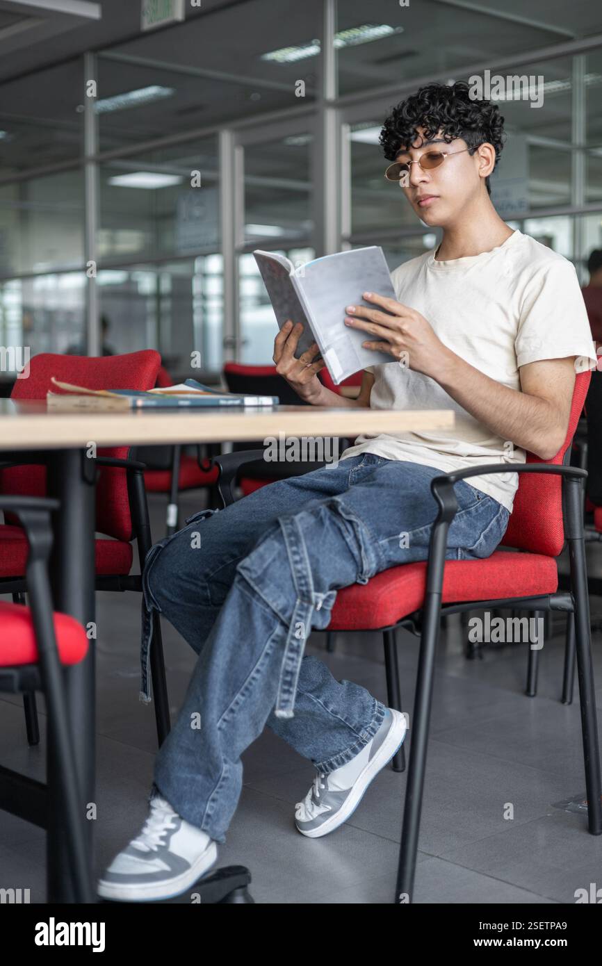 A person sitting at a table, ready to order in a restaurant. Perfect for themes of dining, food, restaurant experience, and casual dining. Stock Photo