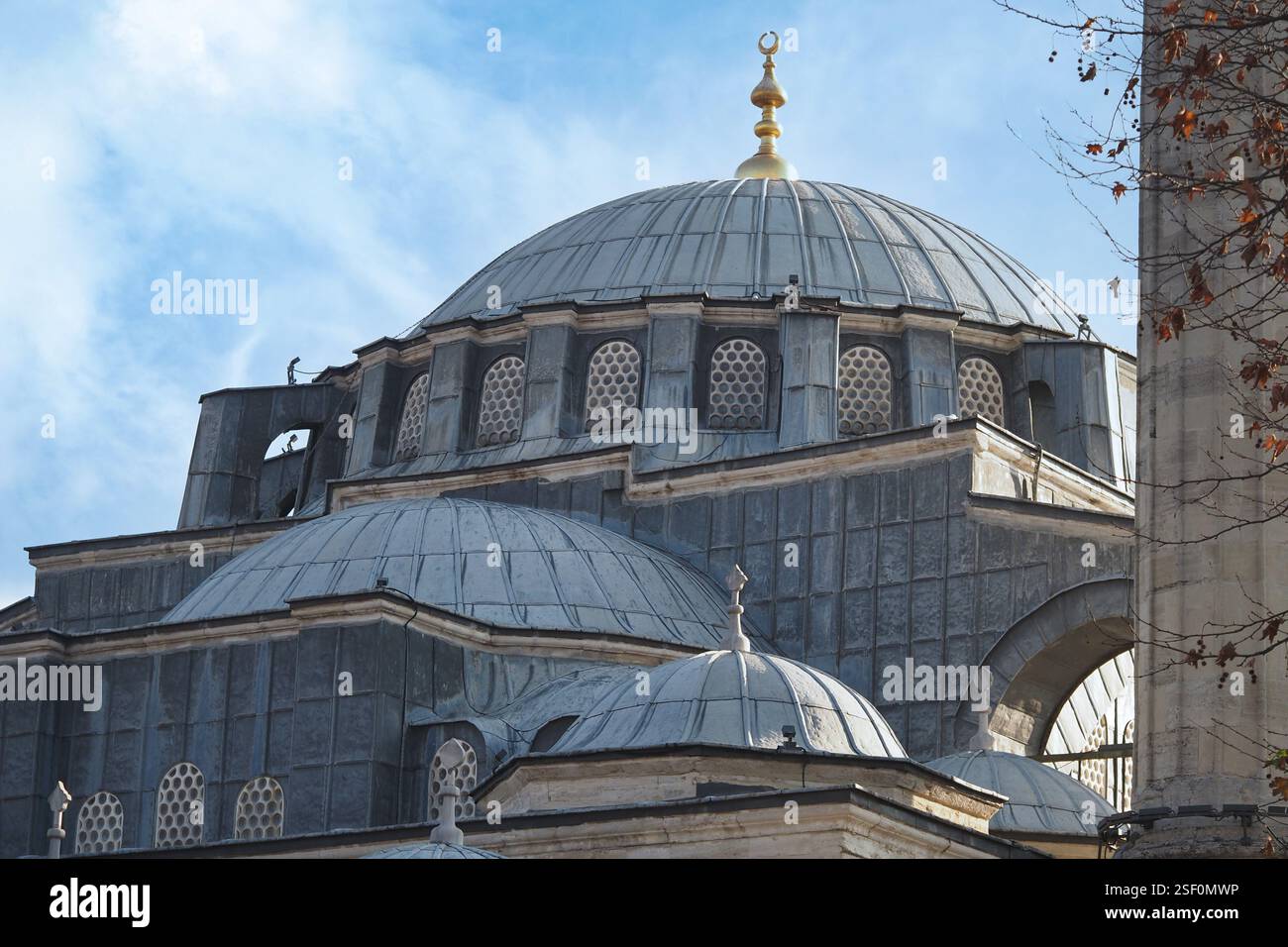 Historic mosque dome under a blue sky with golden crescent Stock Photo ...