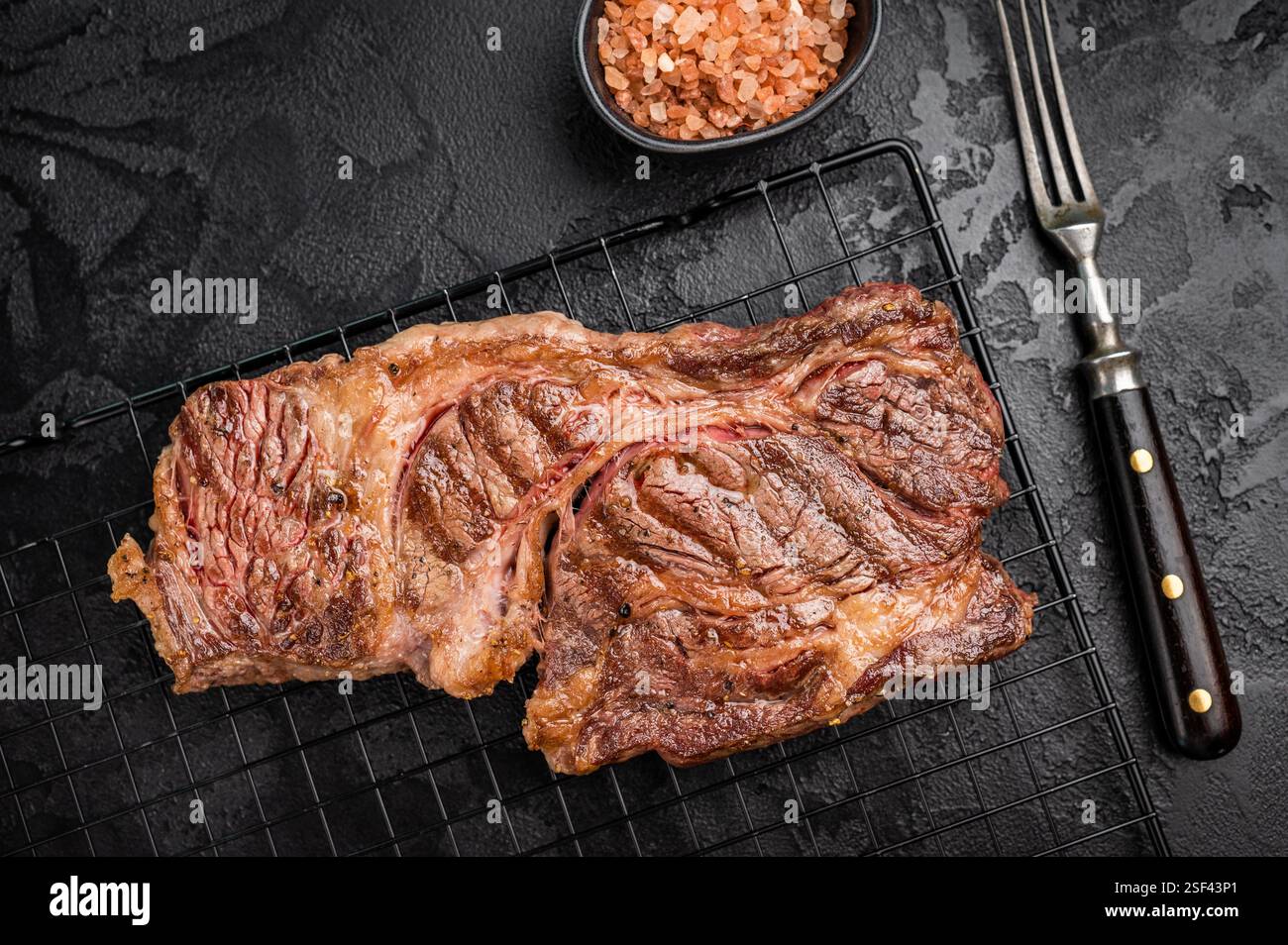 BBQ grilled Chuck eye roll steak, prime beef meat on a steel rack ...