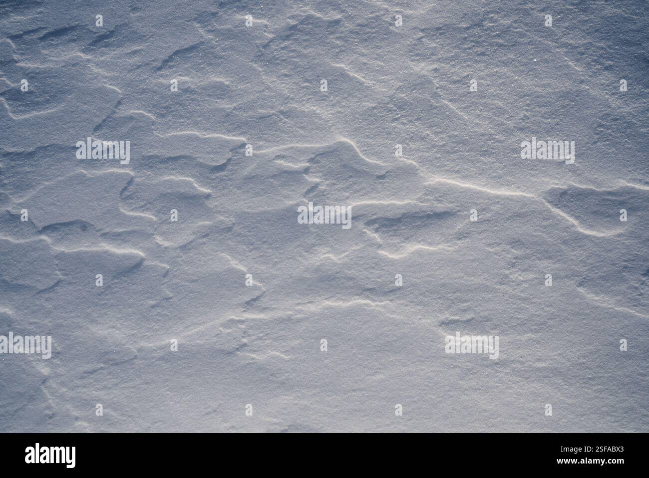 Shapes, textures, patterns created by snow and wind. Stock Photo