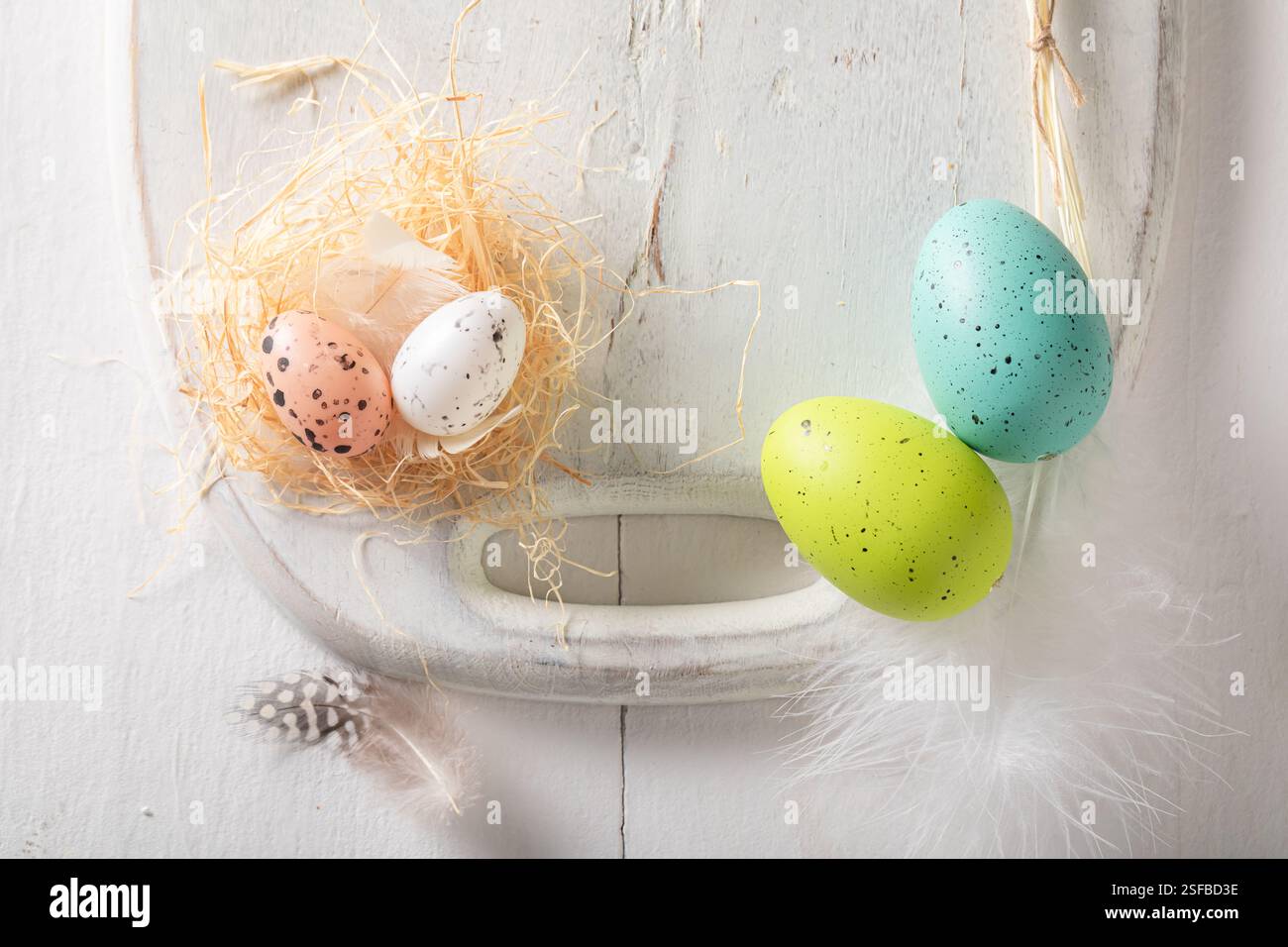 Creative Easter frame for a holiday card. Easter background made of Easter eggs and nest. Stock Photo