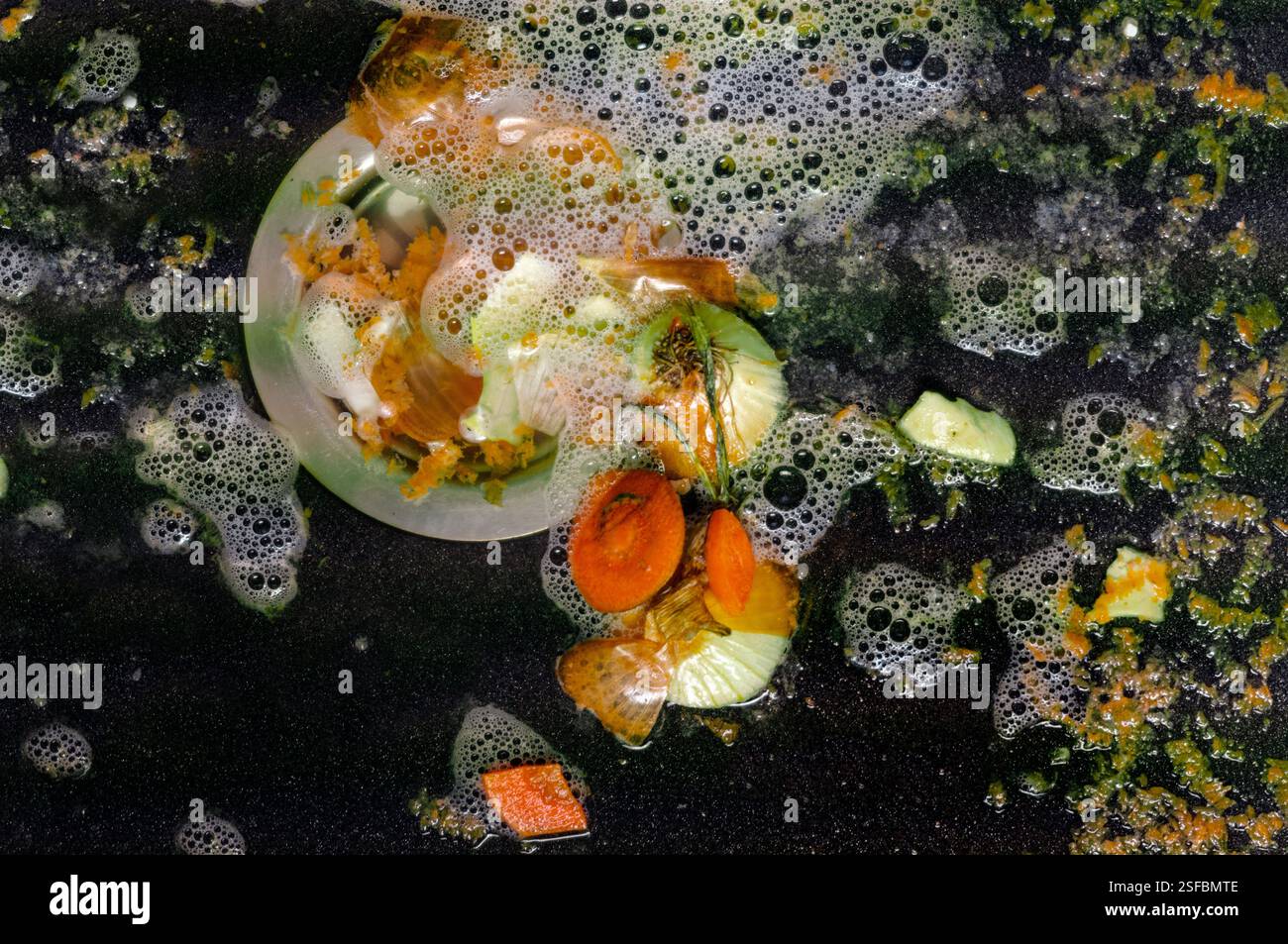 leftovers and foam in a kitchen sink, indoor close up Stock Photo