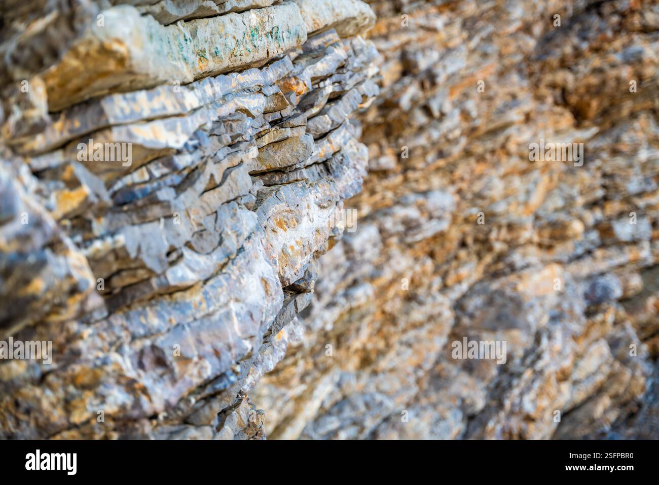 Layered rock texture in Budva, Montenegro. Sedimentary rocks with ...