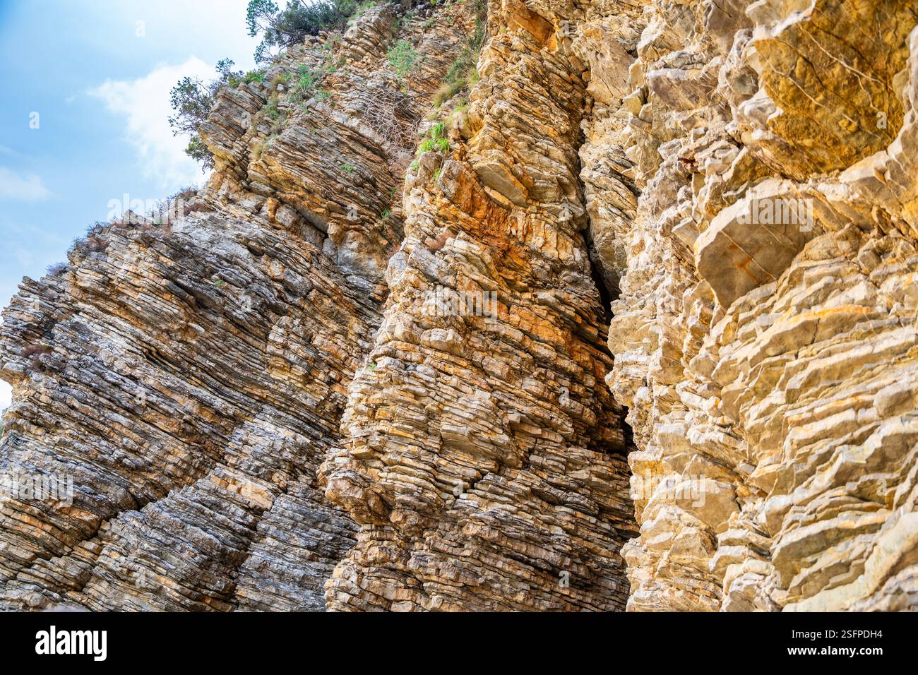 Layered rock texture in Budva, Montenegro. Sedimentary rocks with ...