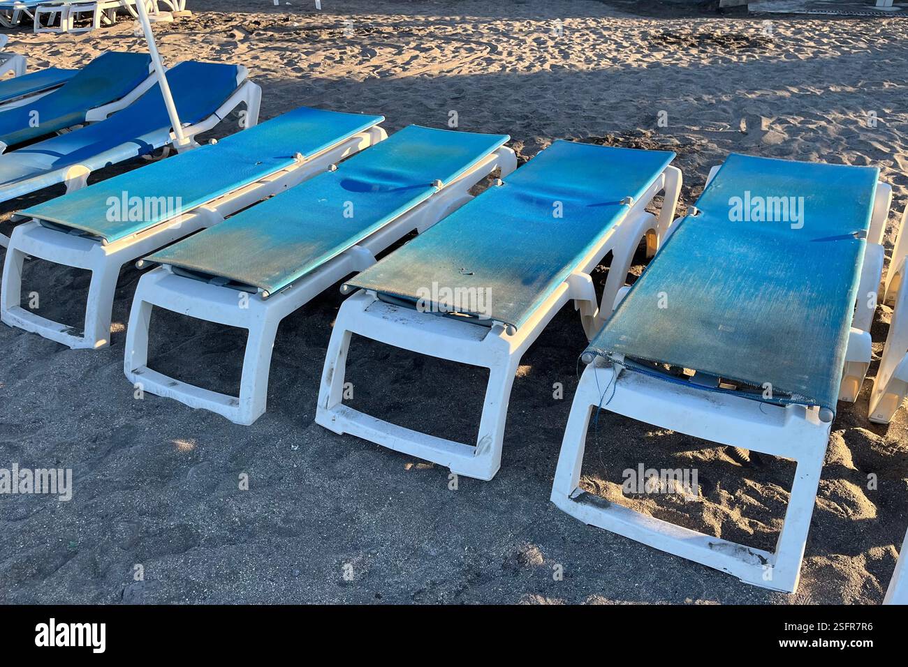 Blue Sun Loungers in the flat position on Fanabe Beach in Costa Adeje. Tenerife, Canary Islands, Spain. 12th January 2025. - Smartphone Captured Stock Image