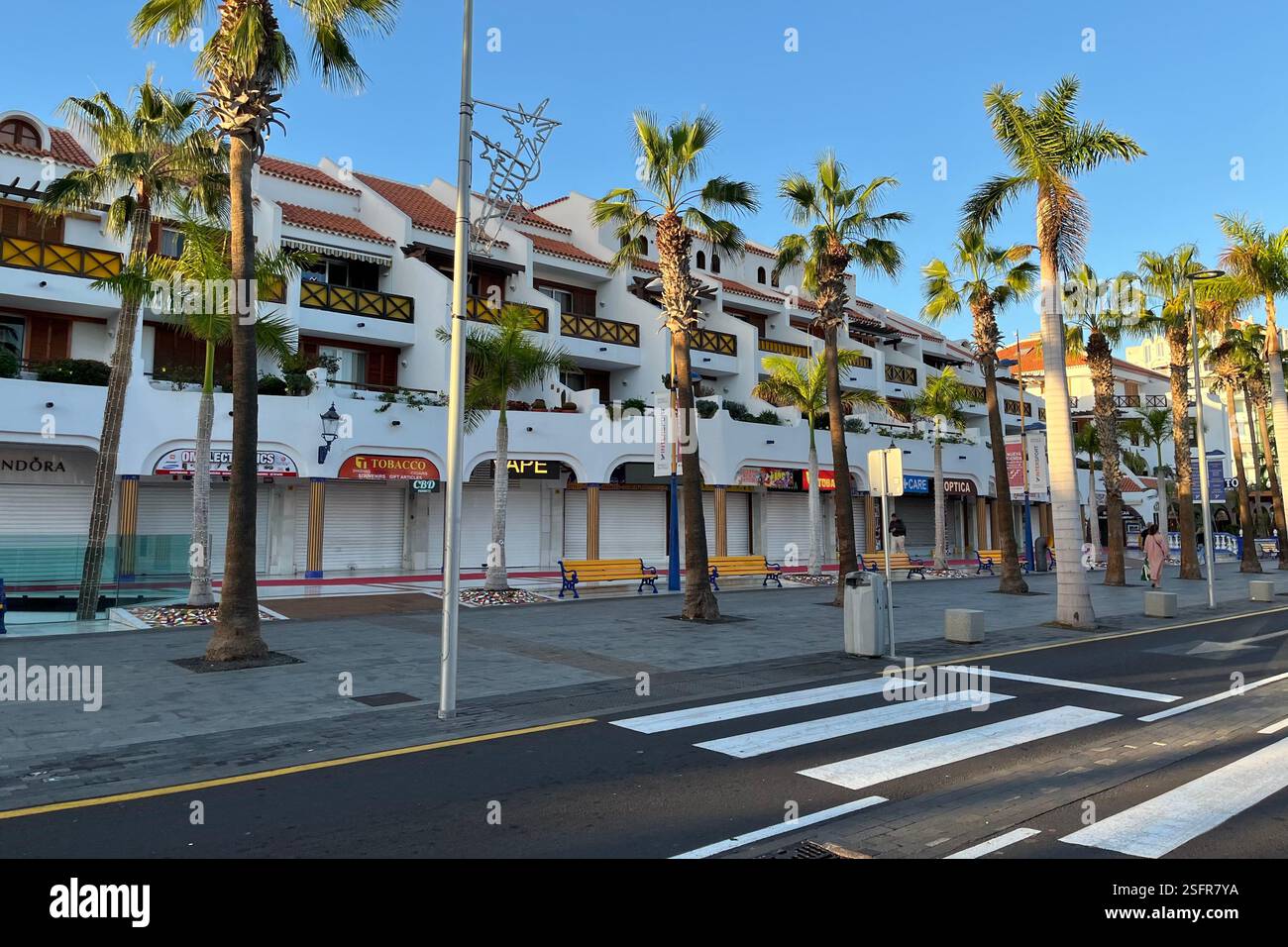Shops and Apartments of the Parque Santiago Complex at dawn on the Golden Mile in Playa de las Américas. Arona, Tenerife, Canary Islands, Spain. - Smartphone Captured Stock Image