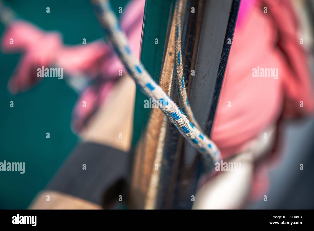 A close-up view of a securely tied rope and knot on a ship mast ...
