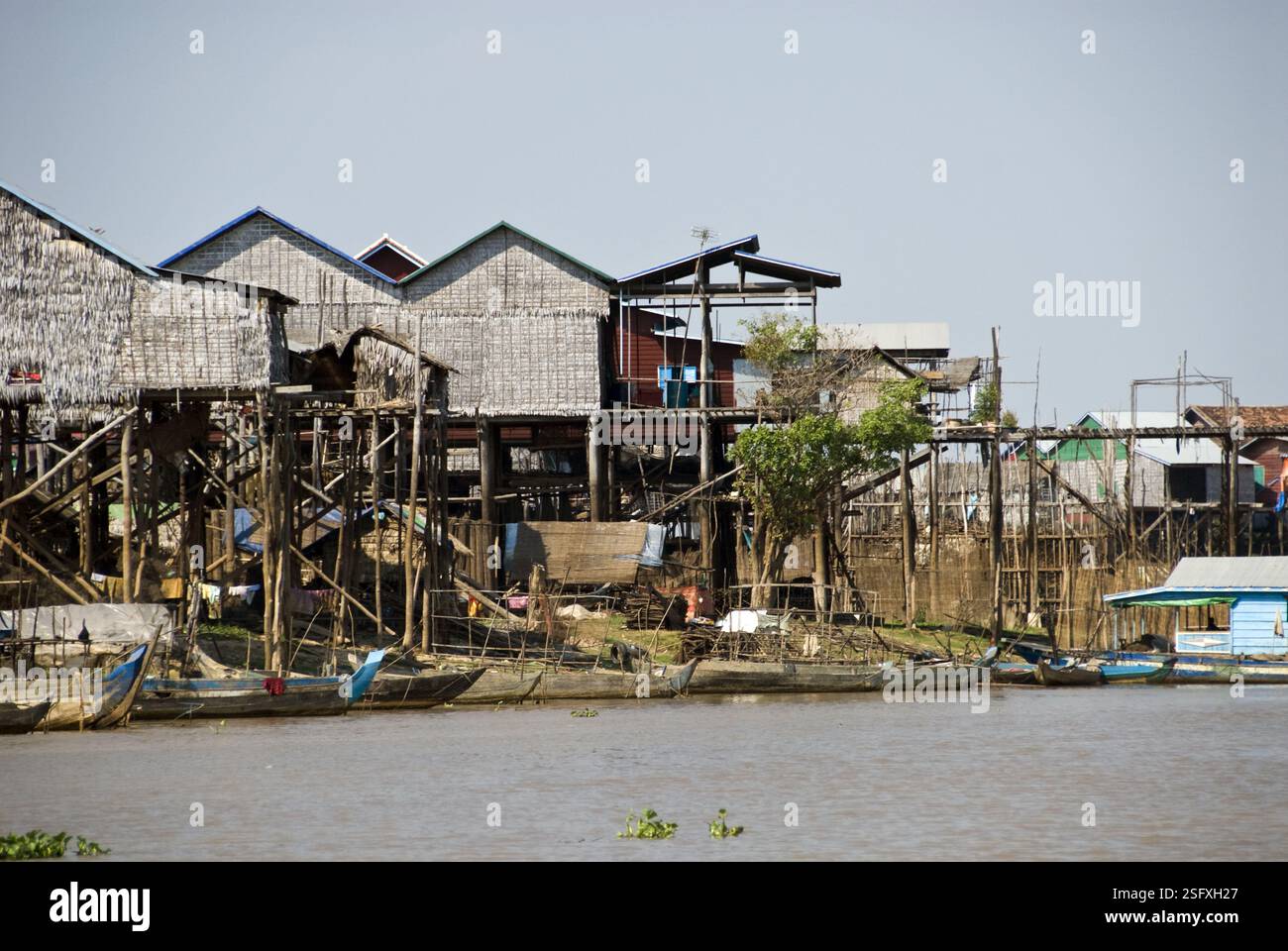Houses are built on stilts over river next to Tonle Sap Lake, which ...