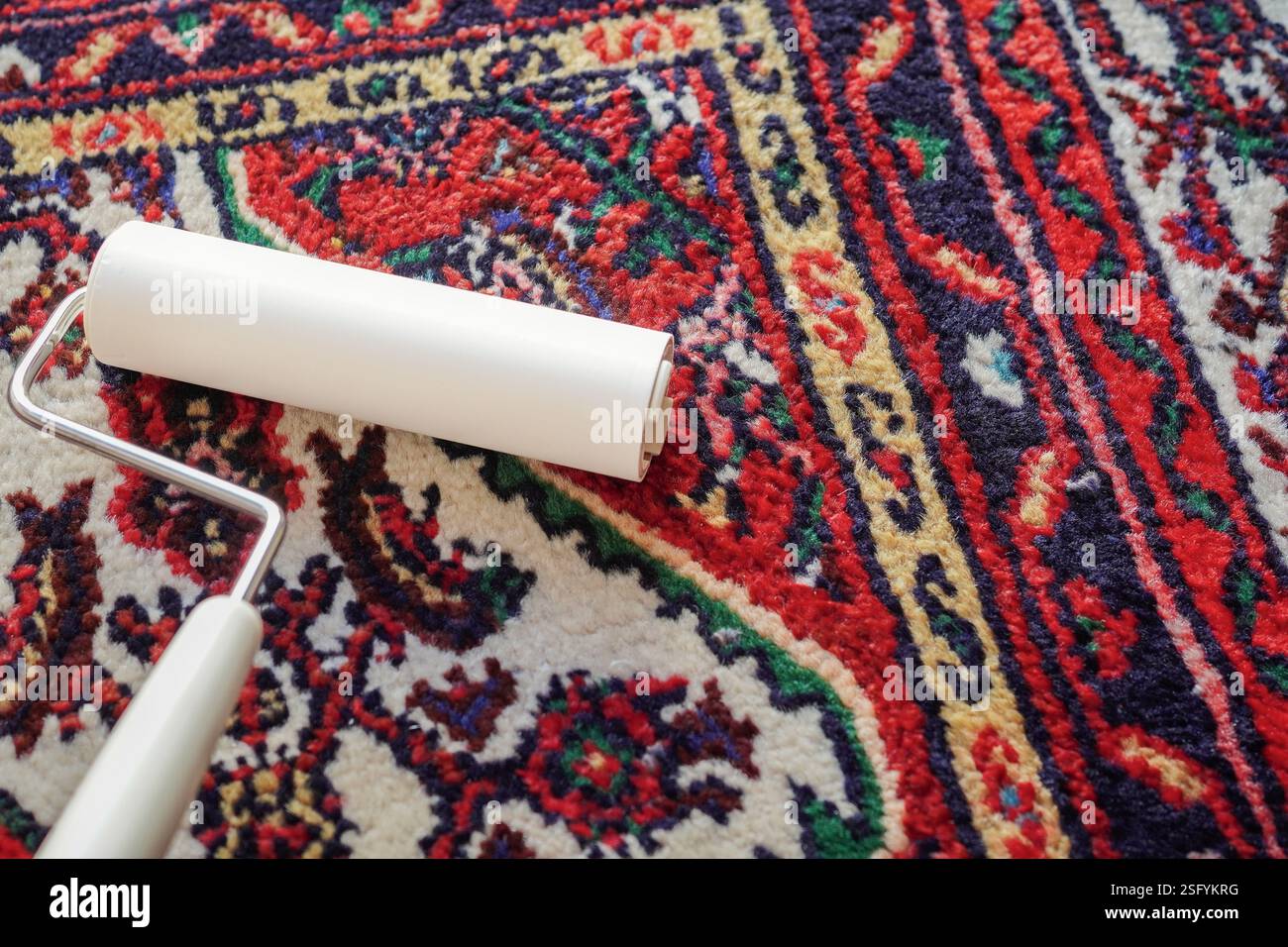 Cleaning with a lint roller ( carpet cleaner) Stock Photo
