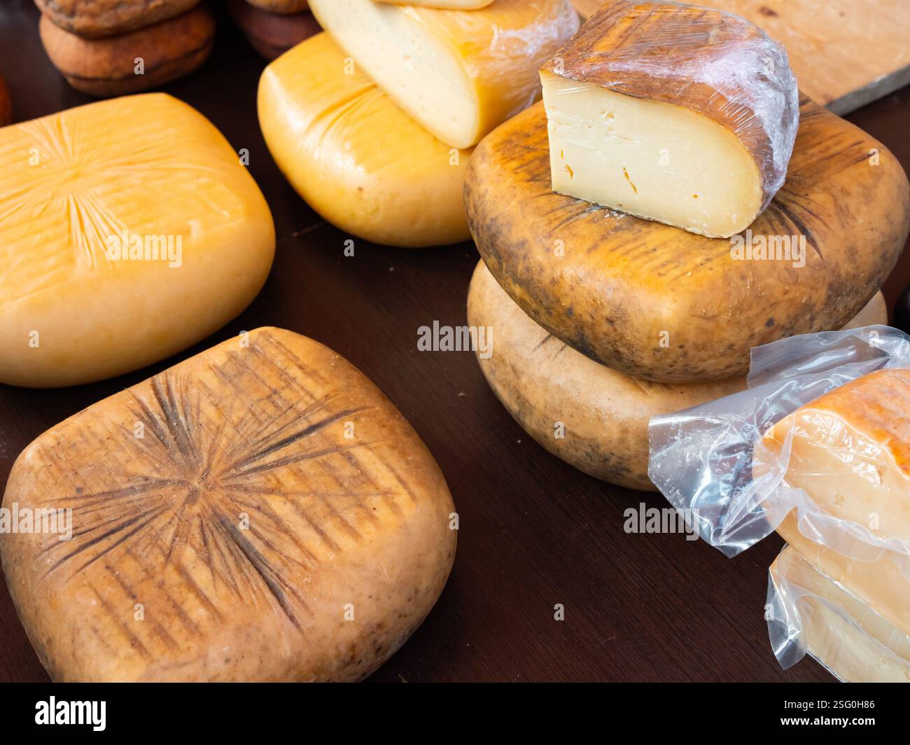 Different types of yellow cheese put on counter in the market Stock ...