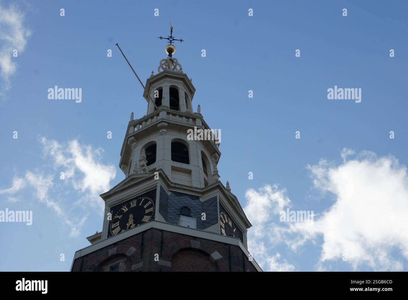 A tall, octagonal clock tower in Amsterdam keeps track of time with a ...