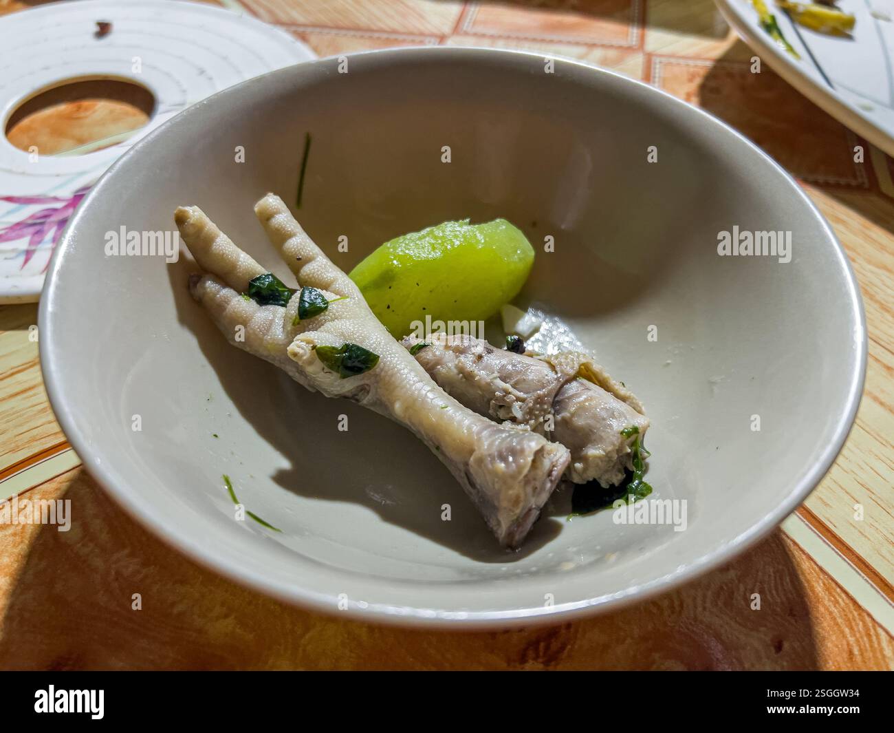 Chicken feet served with green unripe papaya in ginger & fish sauce known as chicken tinola (tinolang manok), traditional Filipino food, Philippines - Smartphone Captured Stock Image