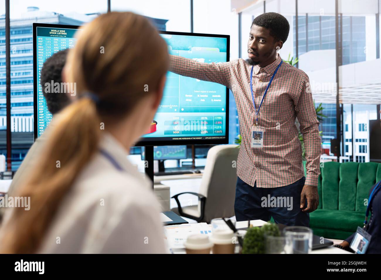 Diverse work team discussing digital marketing trends on interactive board, using analytics to improve sales numbers in a meeting. Business experts developing a startup company. Stock Photo