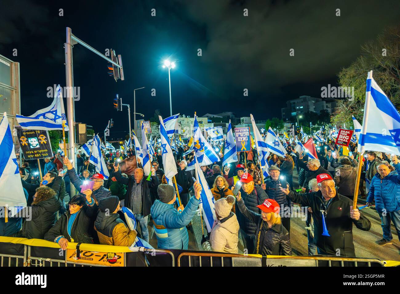Haifa, Israel - February 08, 2025: Crowd of people with various signs ...
