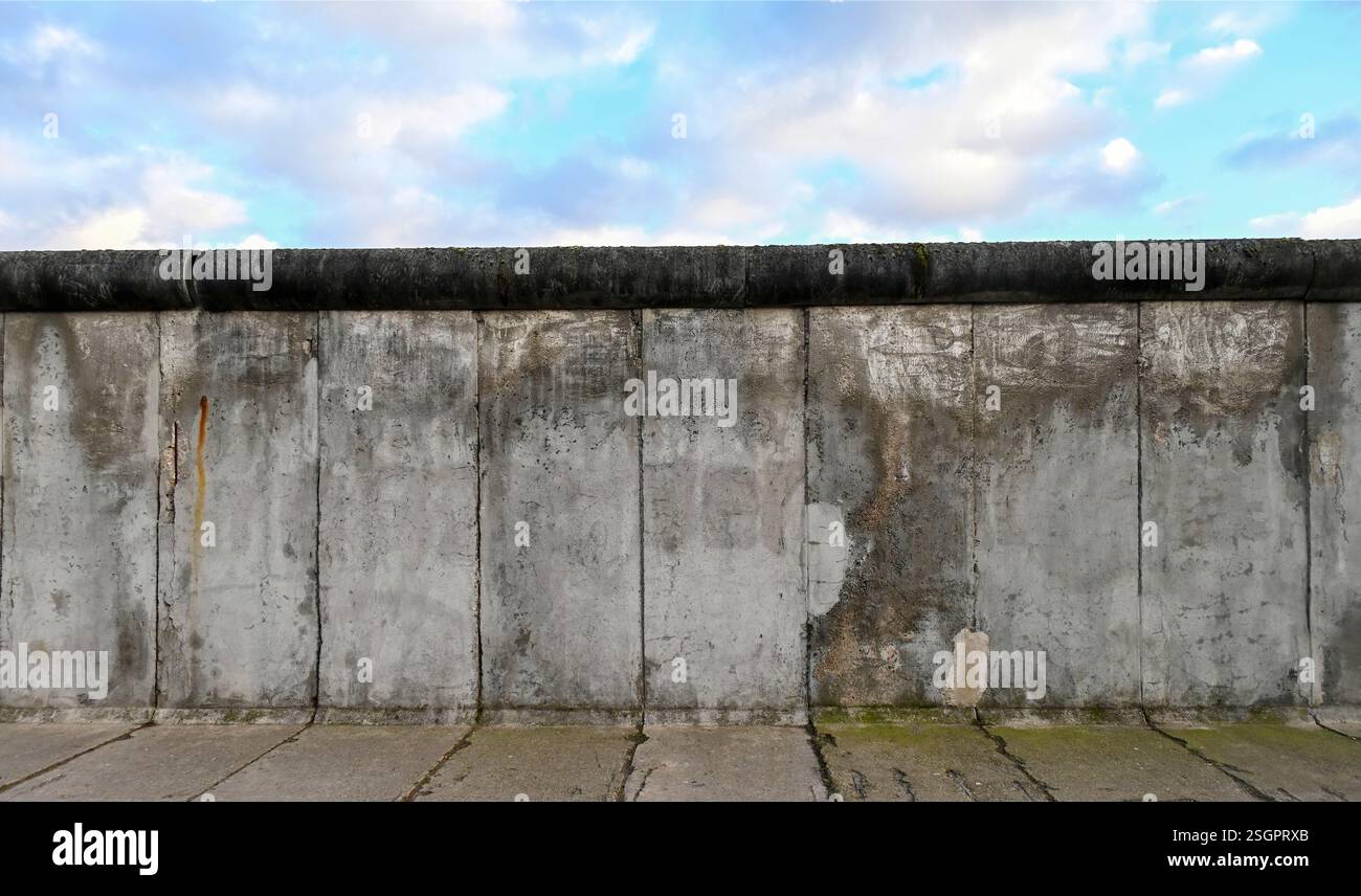 Part of Berlin Wall or Berliner Mauer with blue sky Stock Photo