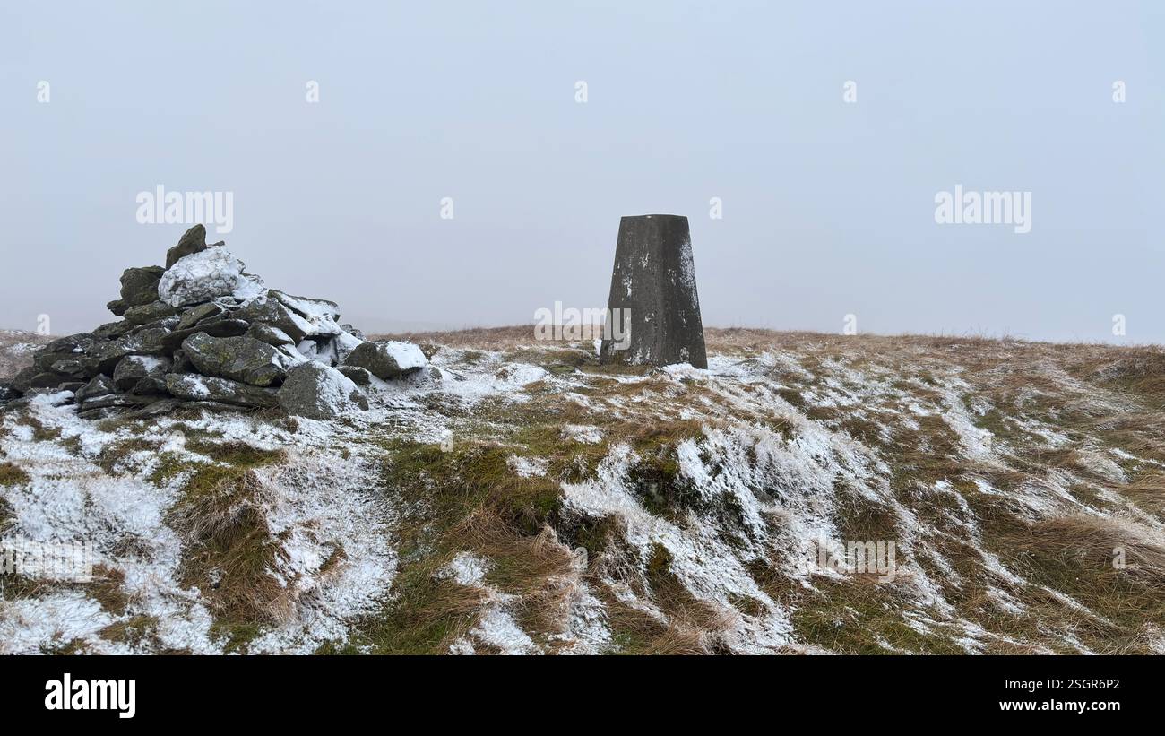 Meall Tarsuinn mountain summit with trig point and cairn in the Scottish Highland mountains in winter with snow. Rolling hills in the outdoors in Scot - Smartphone Captured Stock Image