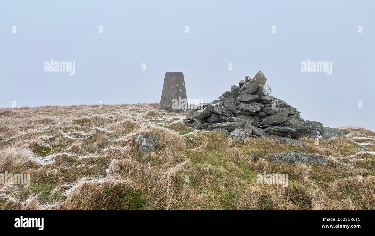 Meall Tarsuinn mountain summit with trig point and cairn in the Scottish Highland mountains in winter with snow. Rolling hills in the outdoors in Scot - Smartphone Captured Stock Image