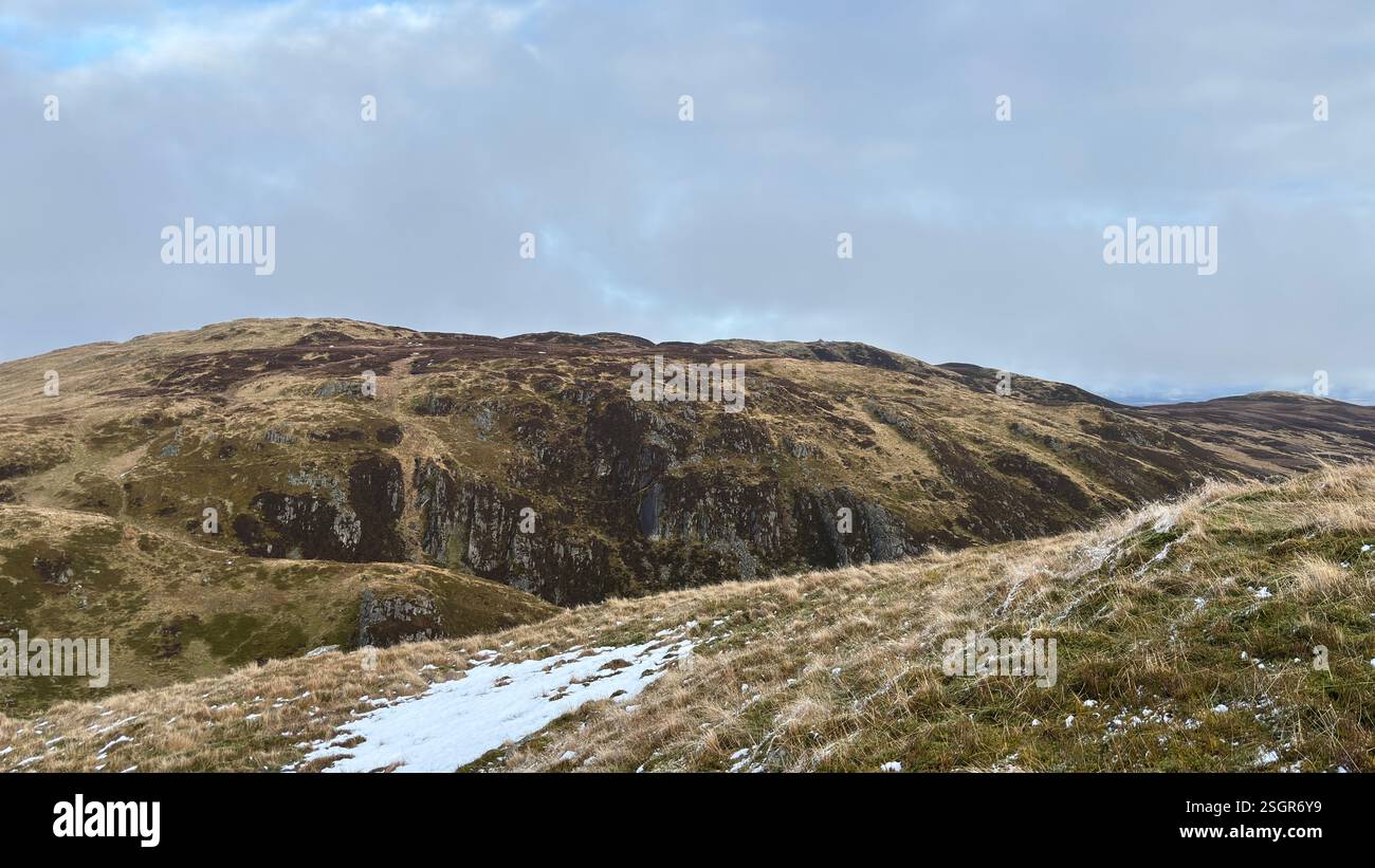 Scottish Highland mountains in winter with snow. Rolling hills in the outdoors in Scotland. Wild nature view across beautiful countryside - Smartphone Captured Stock Image